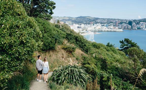 Two people walk on the trail on Mount Victoria in Wellington.