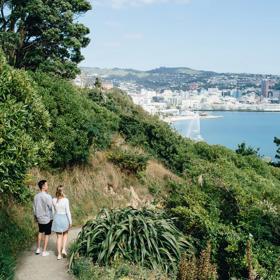 Two people walk on the trail on Mount Victoria in Wellington.