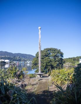 The Petone boat ramp, Hikoikoi,  with colourful boat sheds and boats in the morning sun.