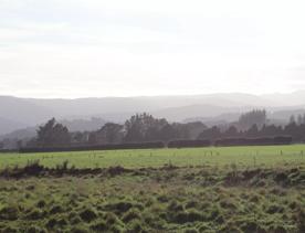 Mangaroa Valley Road screen location, a scenic rural setting with native forest, farmland, and a mountainous backdrop.