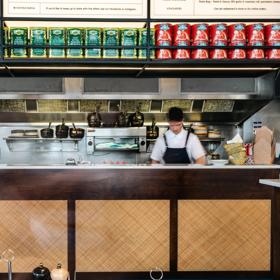 A chef working in the kitchen at 1154 Pastaria on Cuba Street.
