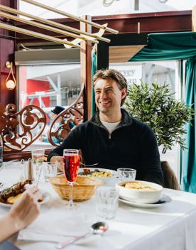 Two friends enjoy French food and drinks at Le Bouillon Bel Air.