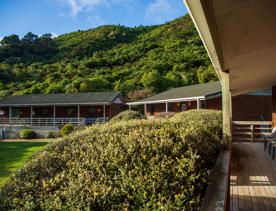 Camp Wainuiomata screen location. Has several buildings and is surrounded by forest and bush.