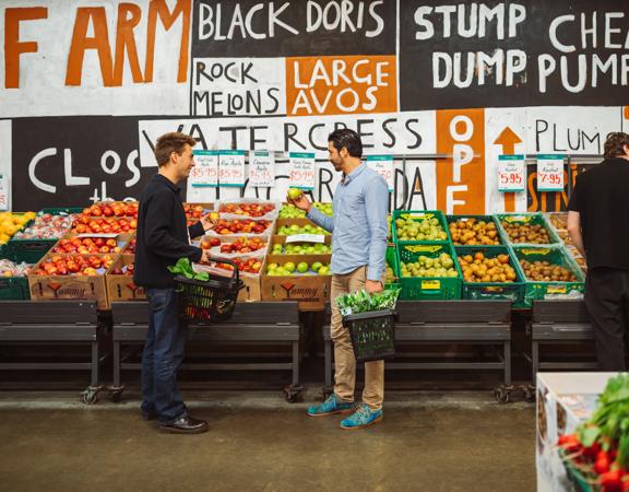 Two people shop for fruit at Moore Wilson's.