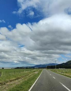 A long straight road leading towards mountains in the distance.