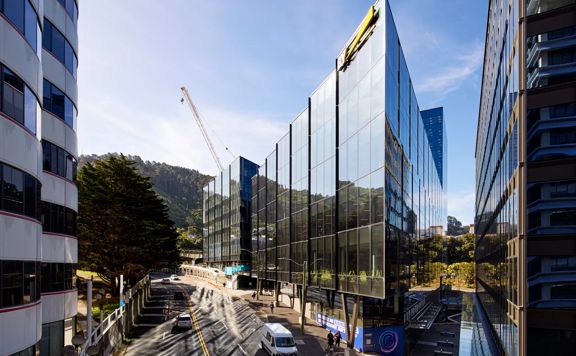 The exterior of buildings on Bowen Campus. The building has a glass facade and Bowen Street curves around.