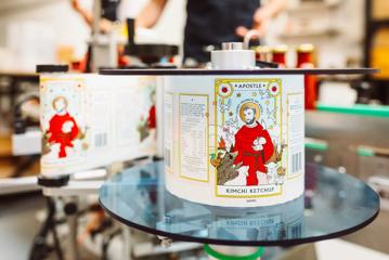 A bottle-labelling machine at Apostle Hot Sauce headquarters in Paraparaumu with a spool of Kimchi Ketchup loaded.