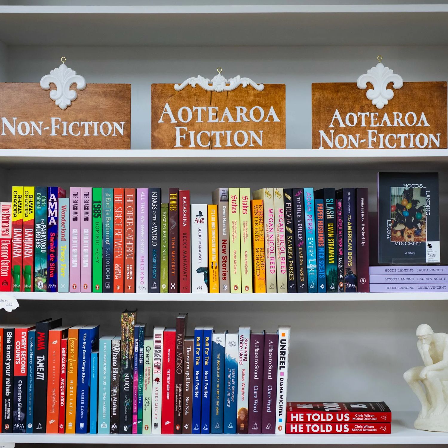 Books on display at Aurelia Books, arranged on white shelves beneath non-fiction and fiction signs.