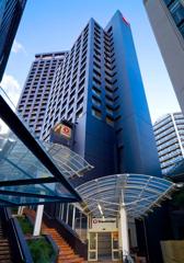 The grey exterior of the Travelodge Hotel. The main entrance is on Plimmer steps.