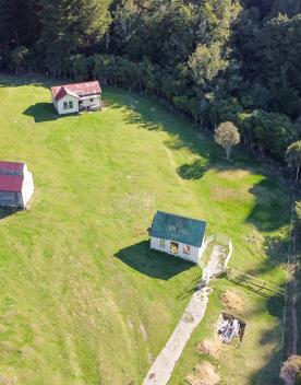 The screen location of Whiitemans Valley, nestled among trees and hills, old buildings have been built to mimic an old town.