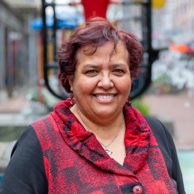 Headshot of Daphne Te Rito Luke, a board member of WellingtonNZ, smiling in front of the Bucket Fountain.