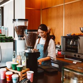 A barista at Sketchbook Coffee works behind the counter.