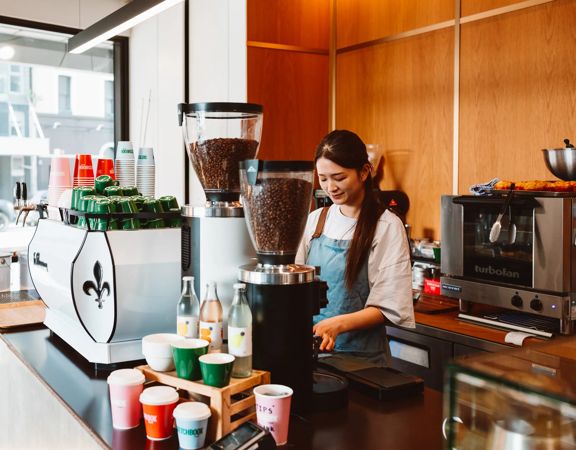 A barista at Sketchbook Coffee works behind the counter.