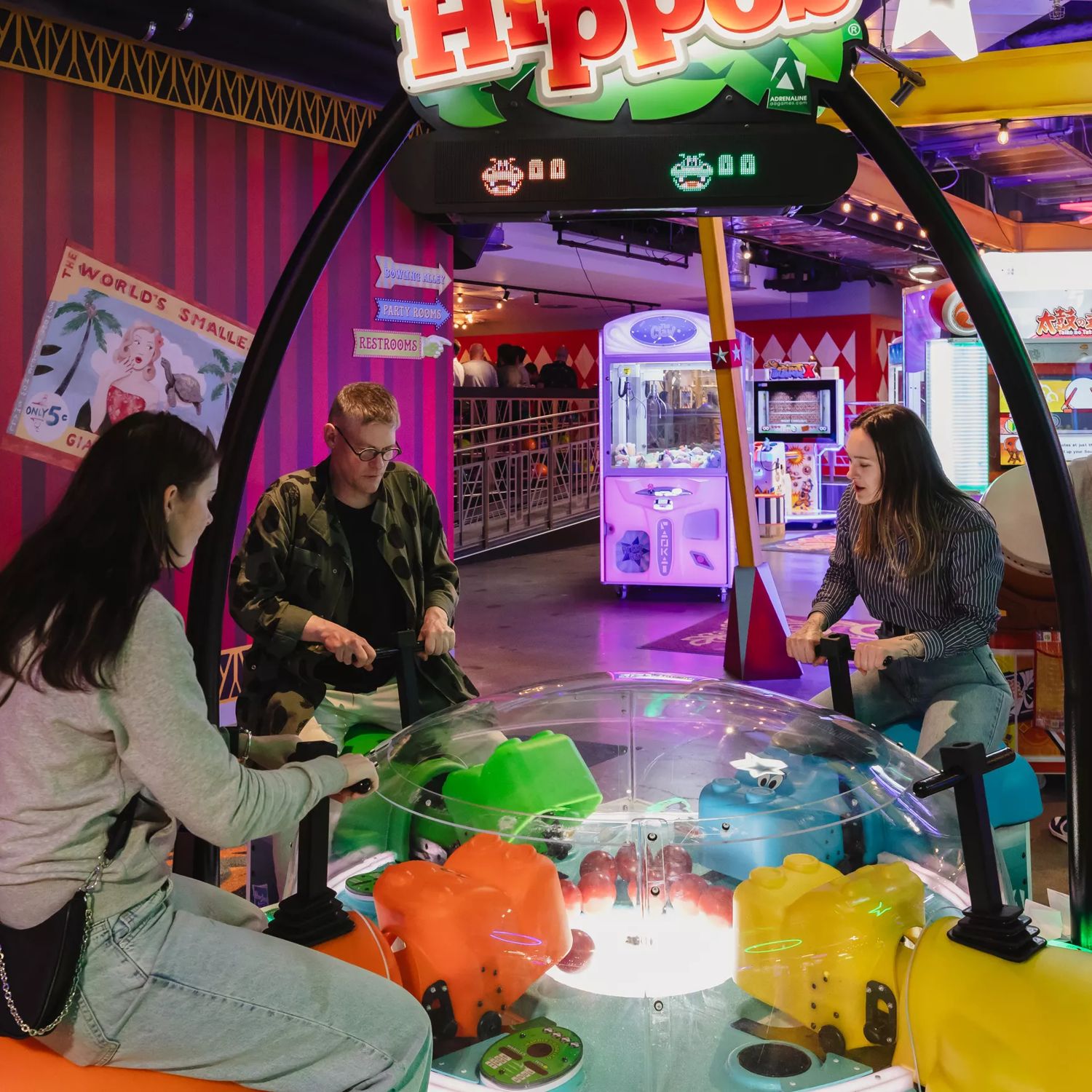 Three people play Hungry Hungry Gippo in Holey Moley, the mini golf course and bar at Willis Lane.