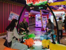 Three people play Hungry Hungry Gippo in Holey Moley, the mini golf course and bar at Willis Lane.