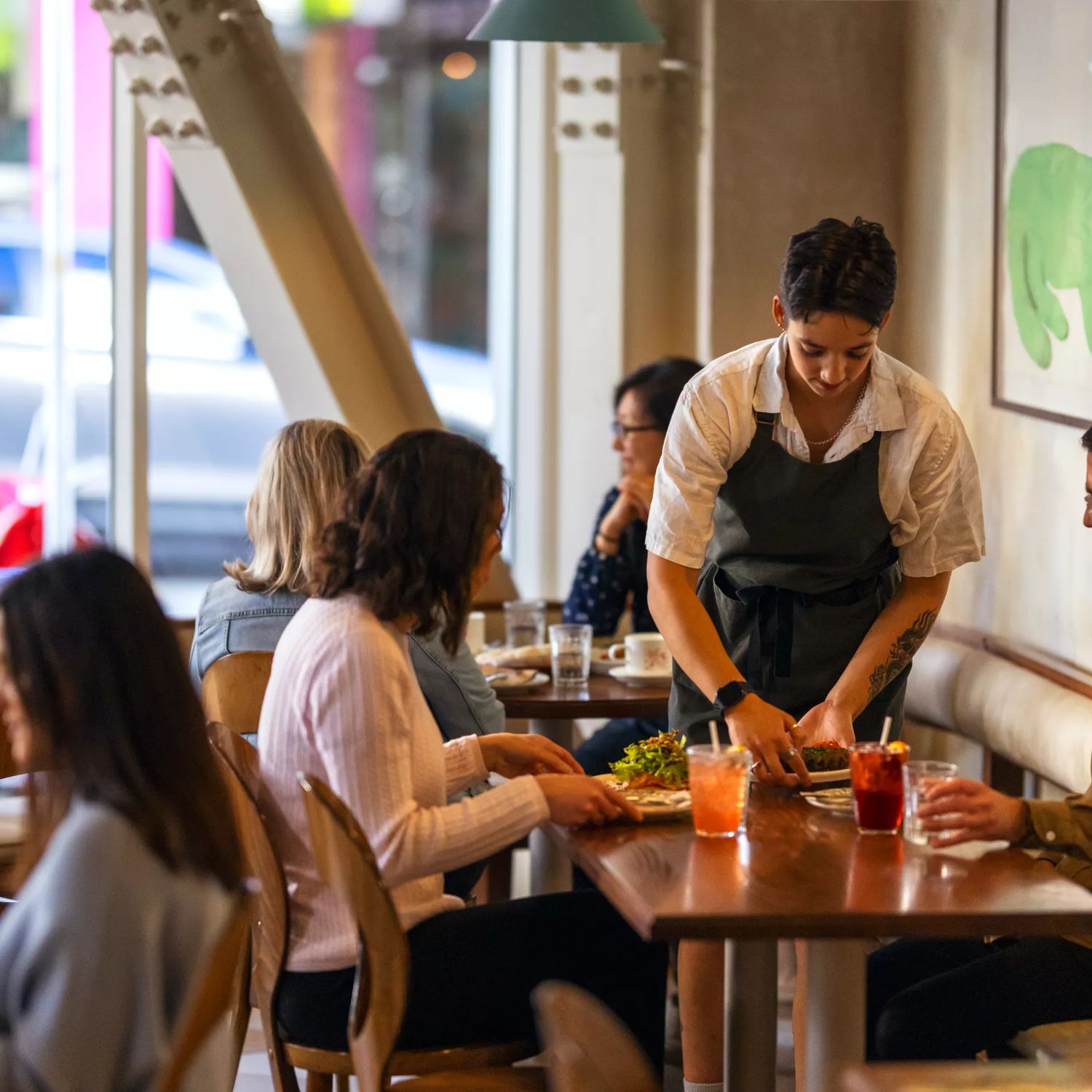 Two people enjoying food and wine at Kisa, a Mediterranean restaurant on Cuba Street in Te Aro, Wellington.