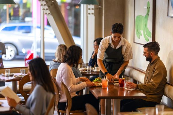 Two people enjoying food and wine at Kisa, a Mediterranean restaurant on Cuba Street in Te Aro, Wellington.