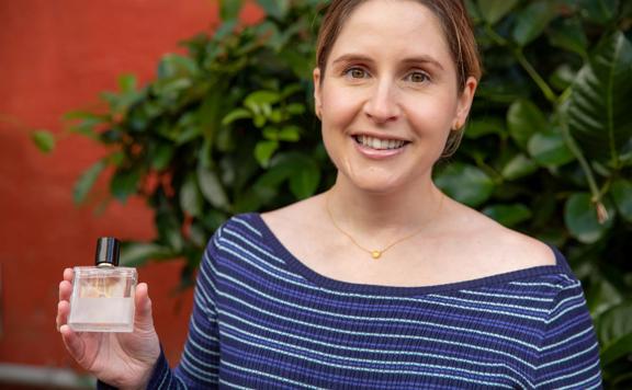 Madeleine Patel, co-founder of Speak Scents a Wellington-based fragrance company, is holding a bottle of perfume.