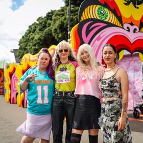 The Dreamgirls Art Collective and Coco Solid in front of their art installation, Taniwha Time Machine, on the waterfront