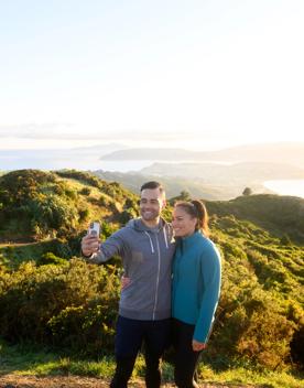 Two people take a selfie on the summit of Rangituhi/Colonial Knob Walkway.