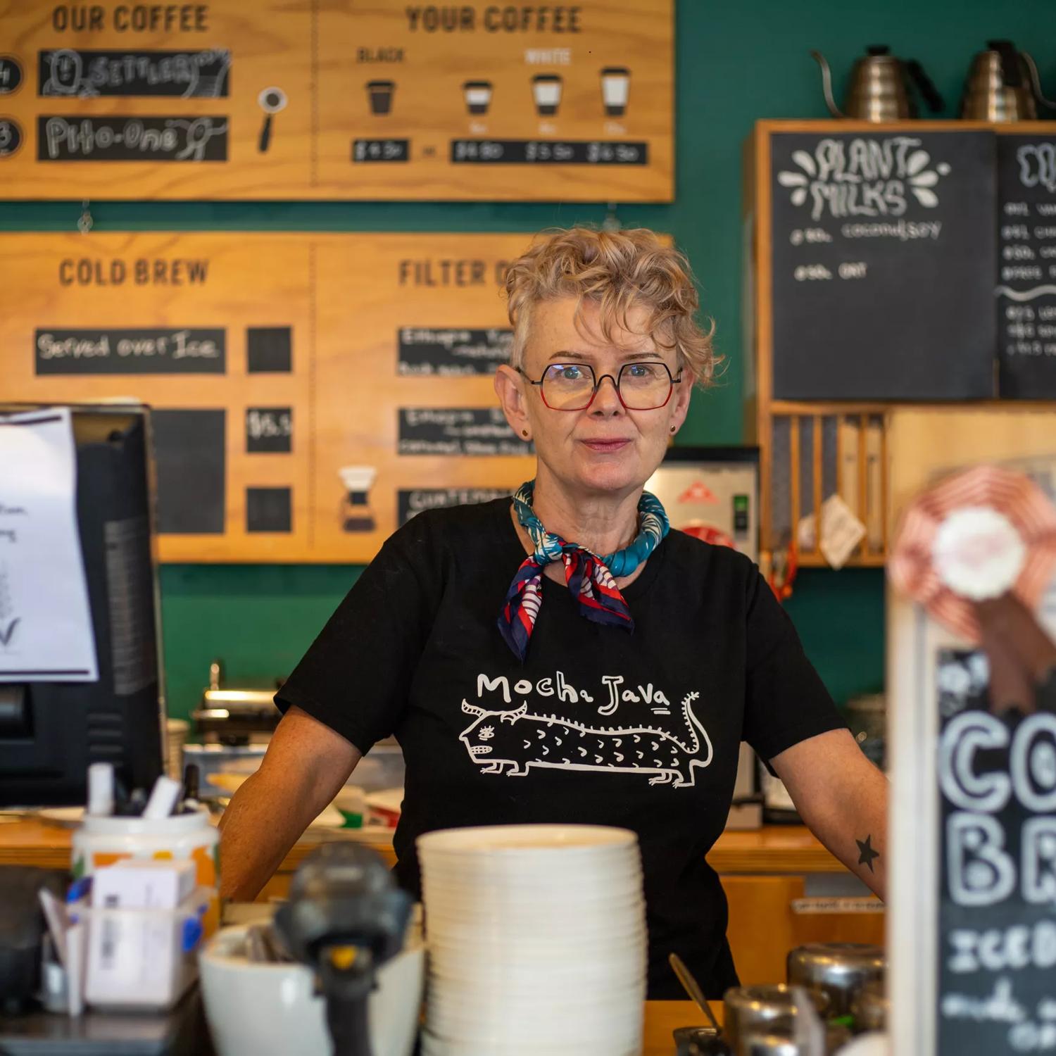 A barista stands behind the counter at the Small Batch flagship café in the heart of Petone.