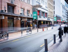 The mix of modern and old buildings along Lambton Quay, including the old supreme court, and old bank.