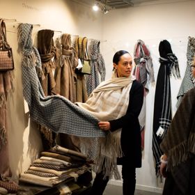 Two people at the Stansborough Mill in Petone shopping for wool scarves.