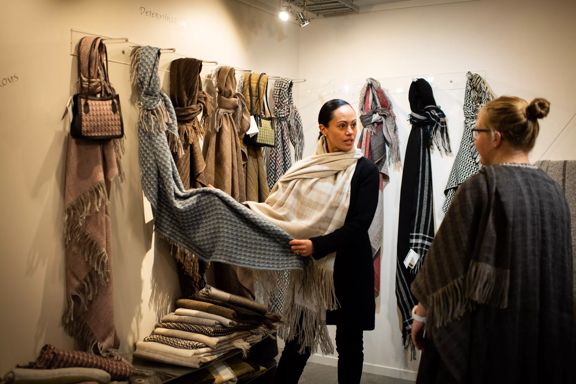 Two people at the Stansborough Mill in Petone shopping for wool scarves.