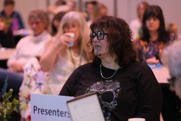 A person sits in the audience at the New Zealand Women in Medicine Conference 2024.