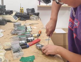 A participant in The Summer of Engineering program working on their Clutterbot project.