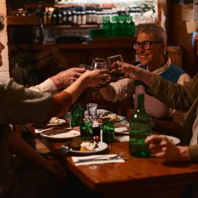 A group of friends toasting their meal at Cicio Cacio Osteria in Newtown, Wellington