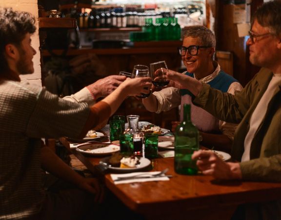 A group of friends toasting their meal at Cicio Cacio Osteria in Newtown, Wellington