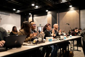 People attend a presentation at APNIC 58 at Tākina.