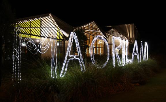 A "Maoriland" sign made of string lights.