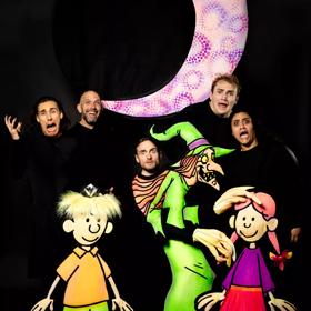 Five cast members of 'Badjelly the Witch Glow Show' wear all black and pose for a photo with the puppet characters from the show.