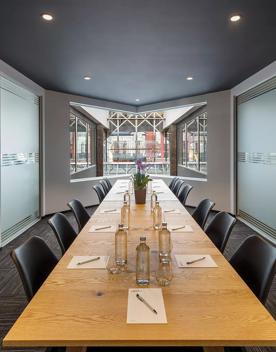 Inside a conference room in Oaks Wellington Hotel, with a long table with 6 chair in the middle of the room.