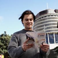 A person doing the Footsteps of Change Wellington Parliamentary Precinct self-guided walking tour with the Beehive building in the background.