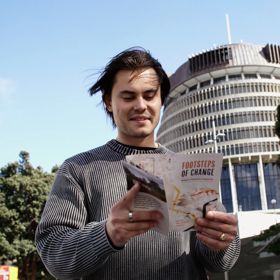 A person doing the Footsteps of Change Wellington Parliamentary Precinct self-guided walking tour with the Beehive building in the background.