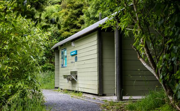 A small green structure housing public toilets at Battle Hill Farm.