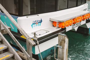 The back of The Ika Rere electric ferry leaves tied to the dock at the Wellington Waterfront.