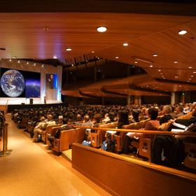 A full house audience inside michael Fowler Centre looking towards the stage.