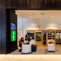 People sit at the information desk of the Wellington isite in Tākina.