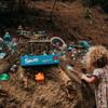 A young child looks at 'the Smurf corner', a manmade fairy village on the Spicer Link Trail.