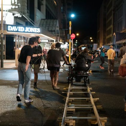 Film crew on a camera dolly track, on Lambton quay.