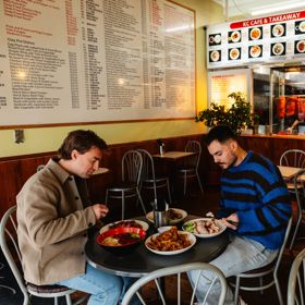 Two friends enjoying asian cuisine at K C Cafe & Takeaway.