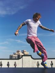 Ed Sheeran dancing on a rooftop.