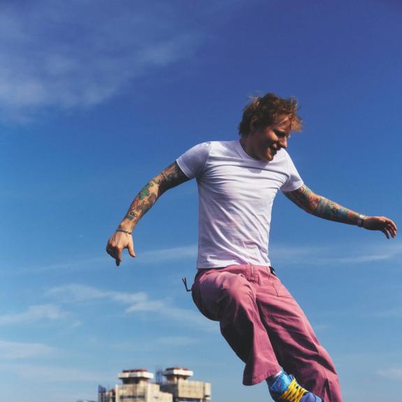 Ed Sheeran dancing on a rooftop.