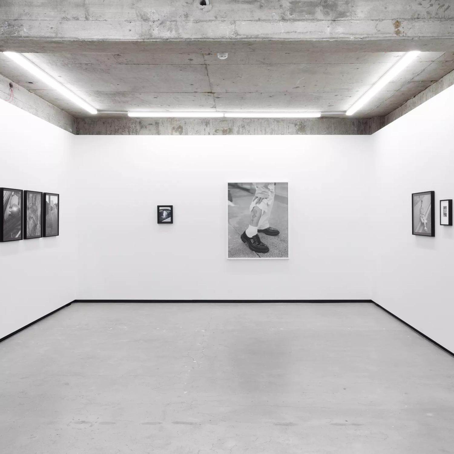 The interior of Jhana Millers, an art gallery located on Victoria Street in Te Aro, Wellington. A black and white photography exhibition is on display.