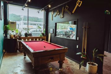 A red felt billiards table at Sweet Axe Throwing Co.