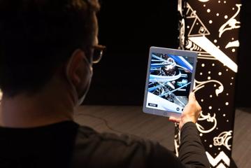 Person holding an iPad at the NZ Game Developers Conference held at the Museum of New Zealand Te Papa Tongarewa.